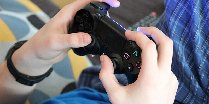 teenager playing video games – video game controller
