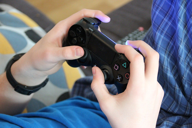 teenager playing video games – video game controller